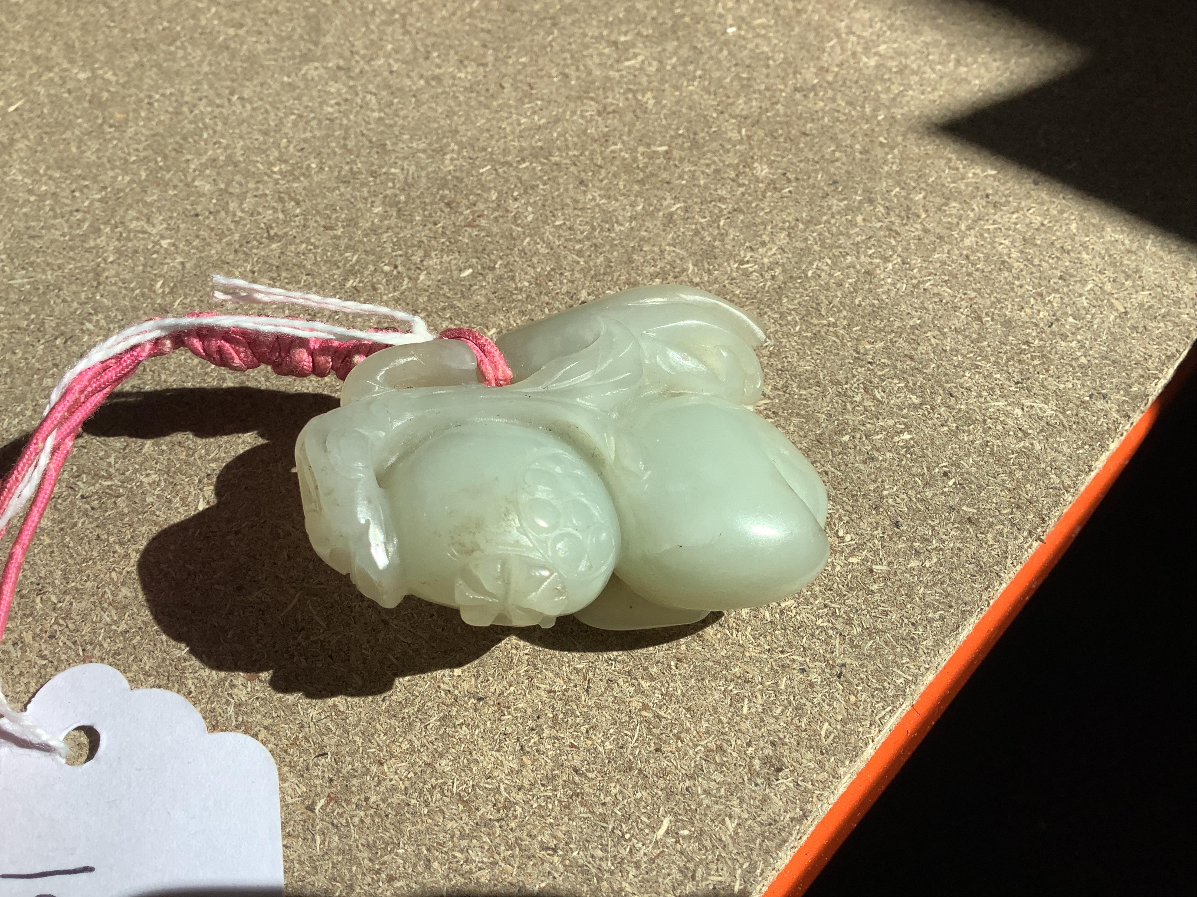 A 19th century jade carving of fruit, 5.5cm wide. Condition - fair, a small piece missing